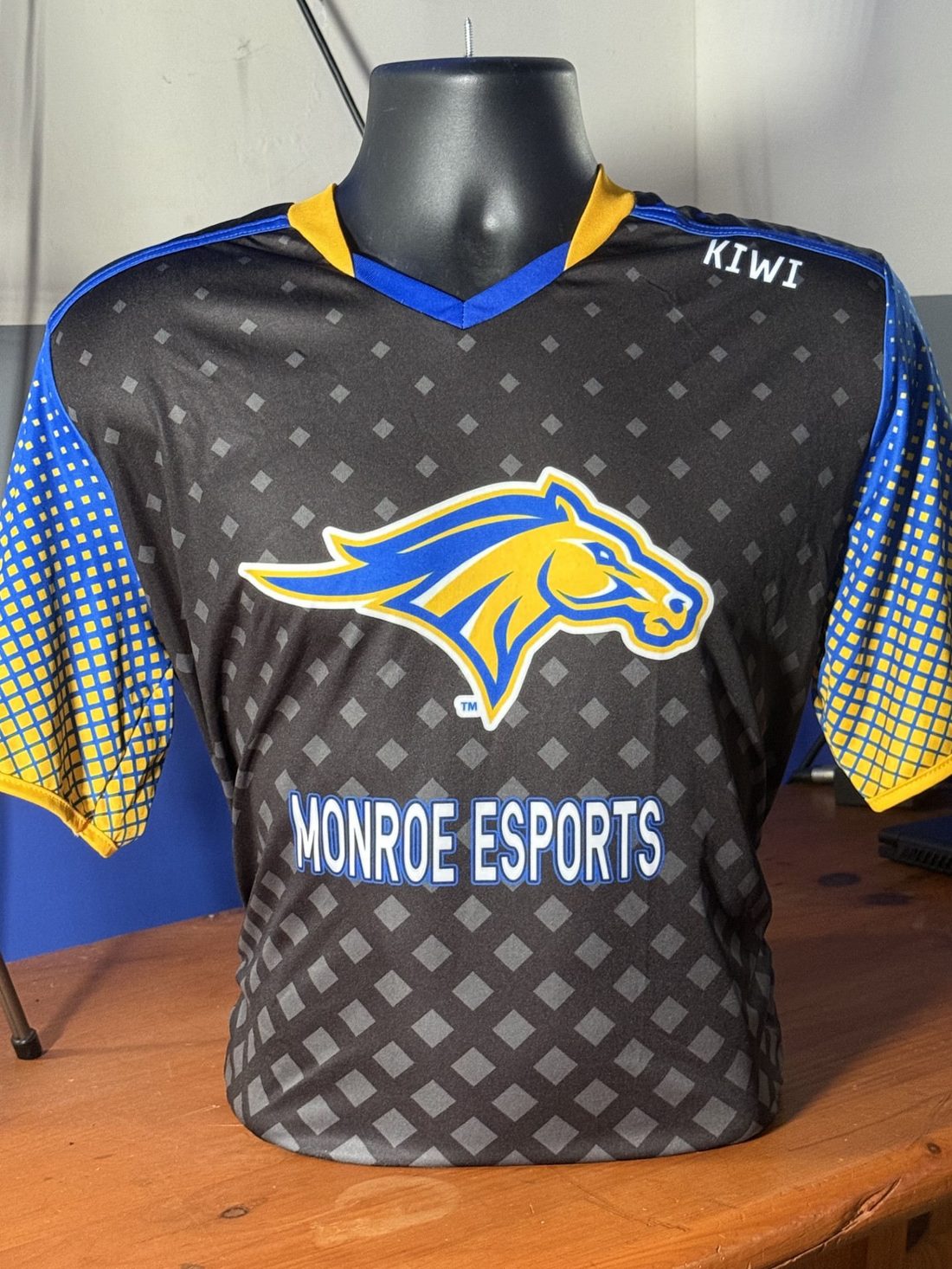 Official Monroe Esports jersey, black with blue and gold sleeves and the Mustang logo